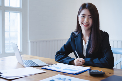 asian female accountant with her financial reports